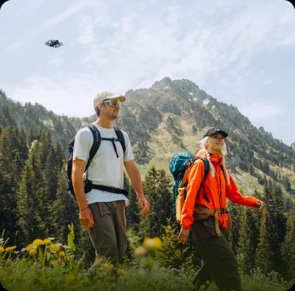 HoverAir X1 PRO self-flying camera following two hikers in the mountains