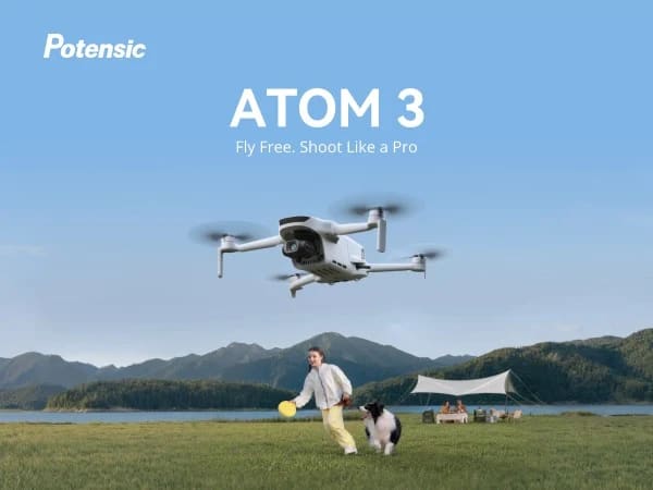 Potensic Atom 3 drone hovering above a lakeside with a person and dog below
