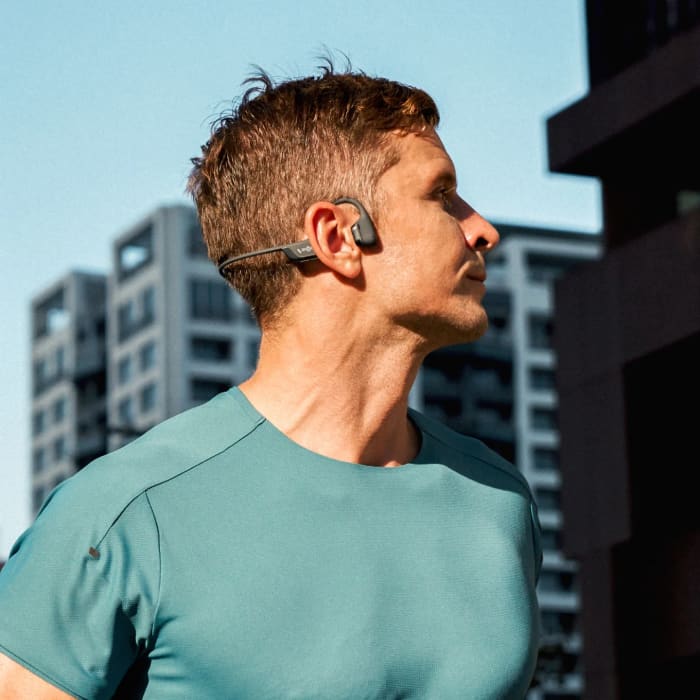 Runner wearing Shokz OpenRun Pro 2 bone-conduction headphones