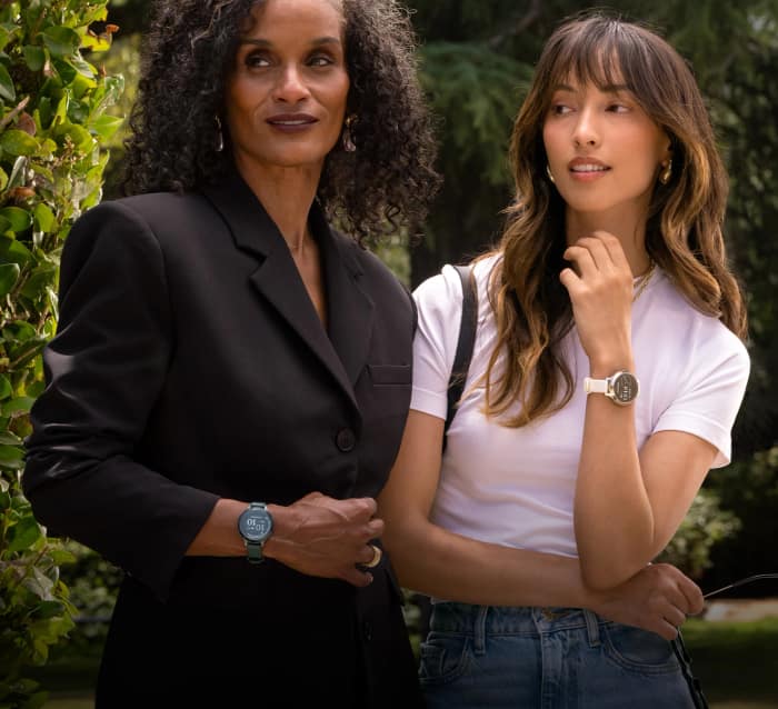 Two women wearing Garmin Lily 2 Active smartwatches outdoors