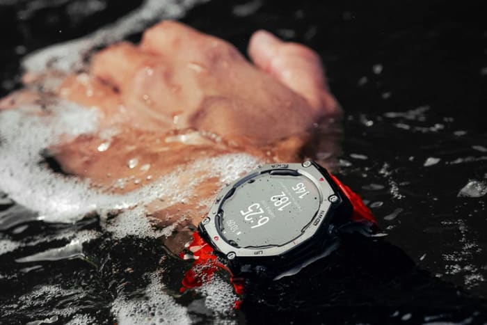 Amazfit T-Rex 3 rugged smartwatch on a wrist in splashing water